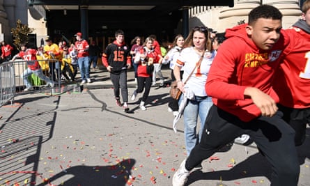 People flee after shots were fired near the Kansas City Chiefs’ Super Bowl LVIII victory parade in Kansas City, Missouri.