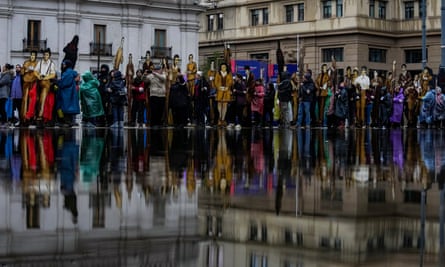 Relatives hold cardboard cutouts of their disappeared relatives at a rally in Santiago in July