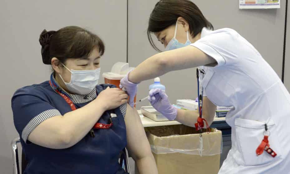 A nurse receives the first dose of the Pfizer COVID-19 vaccine at Fujita Health University Hospital in Toyoake, Aichi prefecture, central Japan,