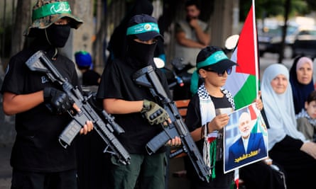 Masked boys hold machine gun toys during a protest to condemn the killing of Hamas political chief Ismail Haniyeh, in the southern port city of Sidon, Lebanon, on 31 July.