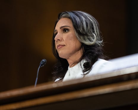 a woman appears nervous sitting in front of a microphone