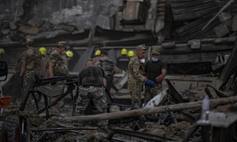 Rescue teams work to remove debris at the Amstor shopping mall targeted by a Russian missile strike in Kremenchuk, Ukraine.