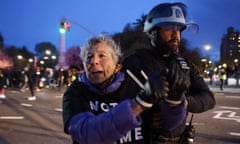 A police officer detains a protester during a protest in Brooklyn, New York, demanding the US government stop arming Israel.