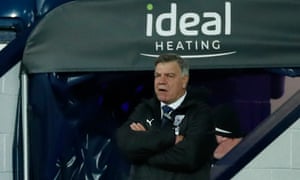 West Brom manager Sam Allardyce looks on.
