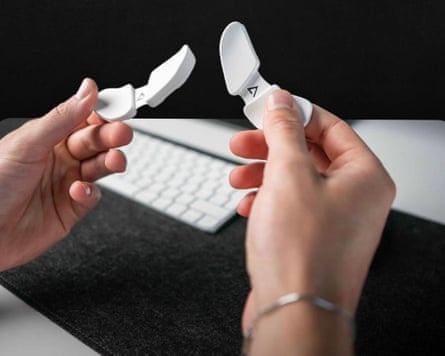 close-up of person holding white wrist rests next to computer keyboard