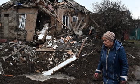 A woman walks past her house that was damaged in Russian shelling also in Kramatorsk.