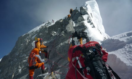 A group of climbers approach the Hillary Step near the summit of Everest. 