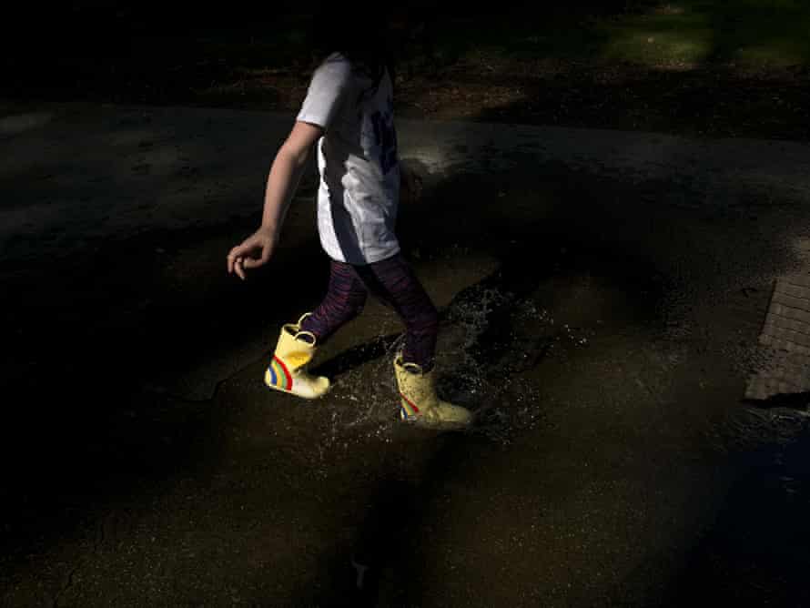 A child splashes in a puddle