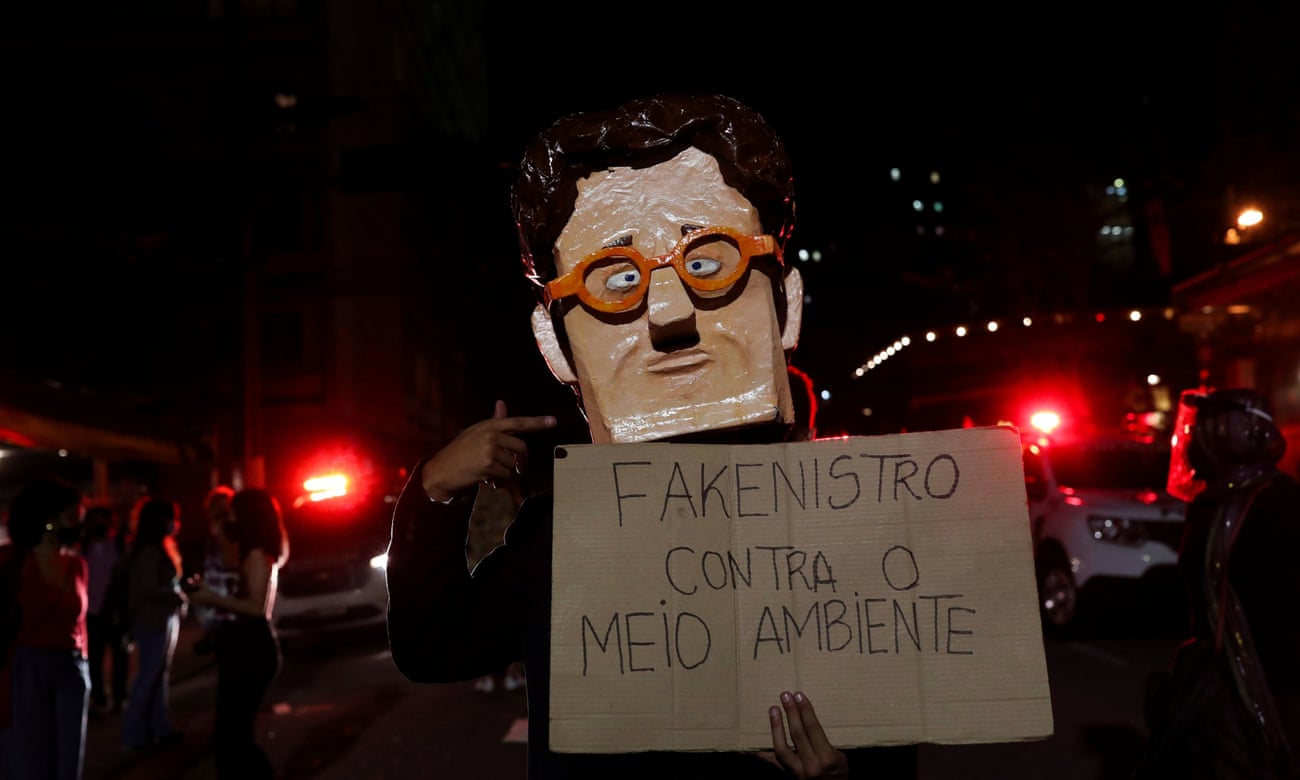 An activist wears a mask depicting Brazil’s environment minister, Ricardo Salles