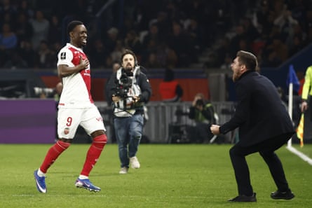 Monaco’s head coach Sebastien Pocognoli roars in delight as Folarin Balogun nears him after his goal.