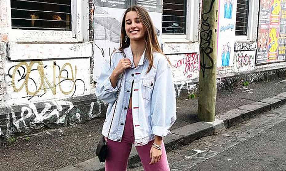 long haired girl in faded denim jacket and pink pants