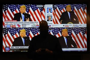 A live broadcast of President Donald Trump speaking from the White House is shown on screens at an election-night party, Tuesday, Nov. 3, 2020, in Las Vegas.