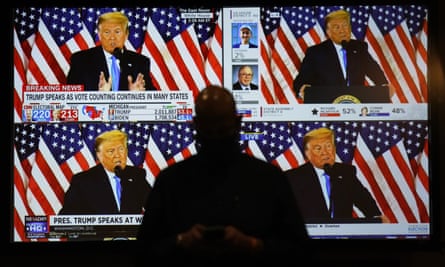 A live broadcast of Donald Trump speaking from the White House is shown on screens at an election night party in Las Vegas on 3 November.