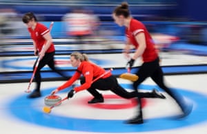 Britain’s Vice Vicky Wright sends a stone down the ice as Hailey Duff (left), and Jennifer Dodds look on during their win over Japan.
