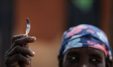 A woman in north-east Uganda shows a homemade tool used for female genital mutilation