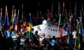 Athletes file into the Carrara Stadium for the closing ceremony.