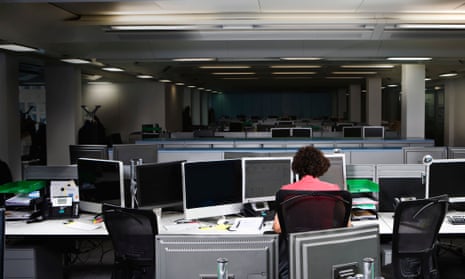 Woman working alone in an office at night