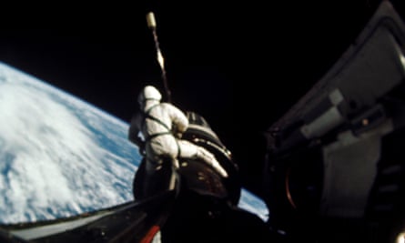 Richard Gordon undertaking a space walk during the Gemini 11 mission, attaching a tether from the Gemini capsule to the Agena vehicle at around 160 nautical miles above Earth, 1966.
