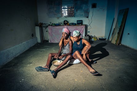 Sally, 32, and Niovis, 33, cut up the piece of chicken they have left to get through the next 23 days until the end of the month