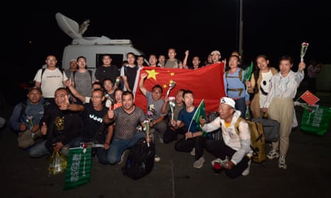 Chinese citizens evacuated from Sudan deploy a large national flag upon their arrival at King Faisal navy base in Jeddah.