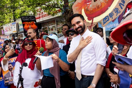 a man holds his hand over his heart as he is surrounded by a group of supporters