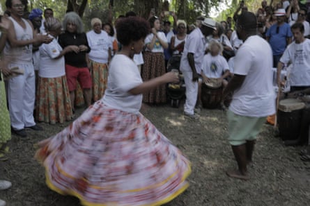 A woman in a skirt dances with a man.