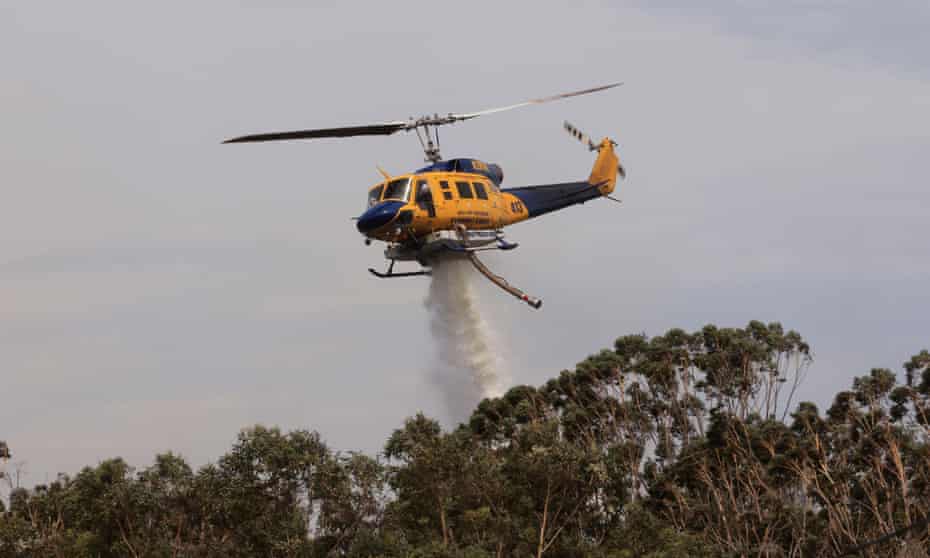 Helicopter water bombing bushfire