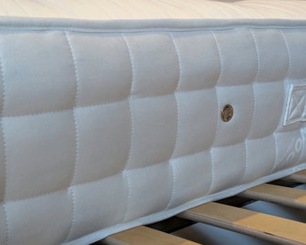 Closeup of the edge of a mattress on slats of wood