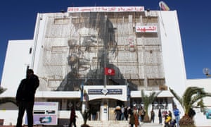 تصویر محمد بوعزیزی در یک ساختمان اداره پست در سیدی بوزیدی ، تونس.