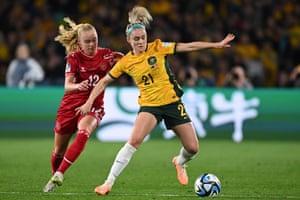 Ellie Carpenter of Australia (right) competes for the ball with Kathrine Kuhl of Denmark.