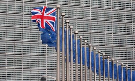 A union jack flag flutters next to EU flags