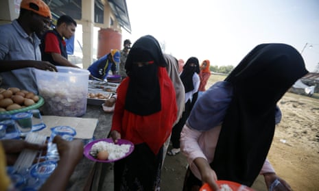 Rohingya refugees queue for breakfast at their temporary camp in Kuala Cangkoi, North Aceh, Indonesia, in June 2015. 
