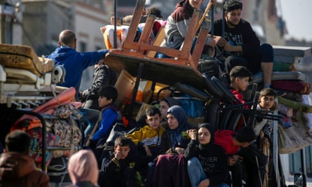 People sit on top of their belongings in Gaza