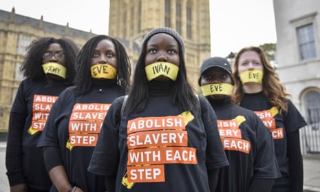 Women with mouths gagged protest against modern slavery