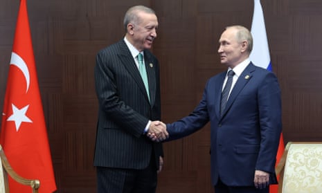 Erdoğan and Putin shake hands at a meeting on the sidelines of a conference in Astana, Kazakhstan.
