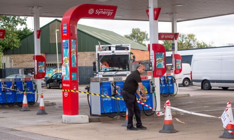 A member of staff tapes off the petrol pump area at the Esso petrol station on the A40 Oxford Road in Denham after they ran out of fuel today
