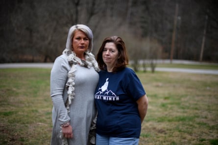 Stephanie Bentley, 44, and Linda Adams, 57, both black lung widows stand outside Bentley’s home in Virgie, Kentucky.