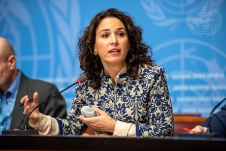 Seated woman speaking into a microphone.