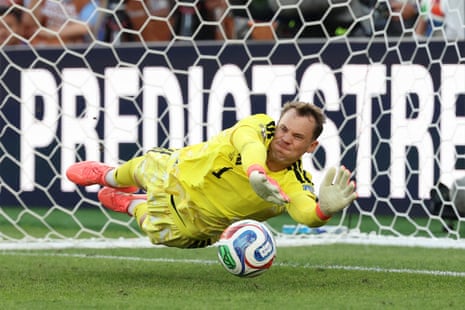 Germany's Manuel Neuer saves a penalty by Paraguay's Fabian Balbuena.