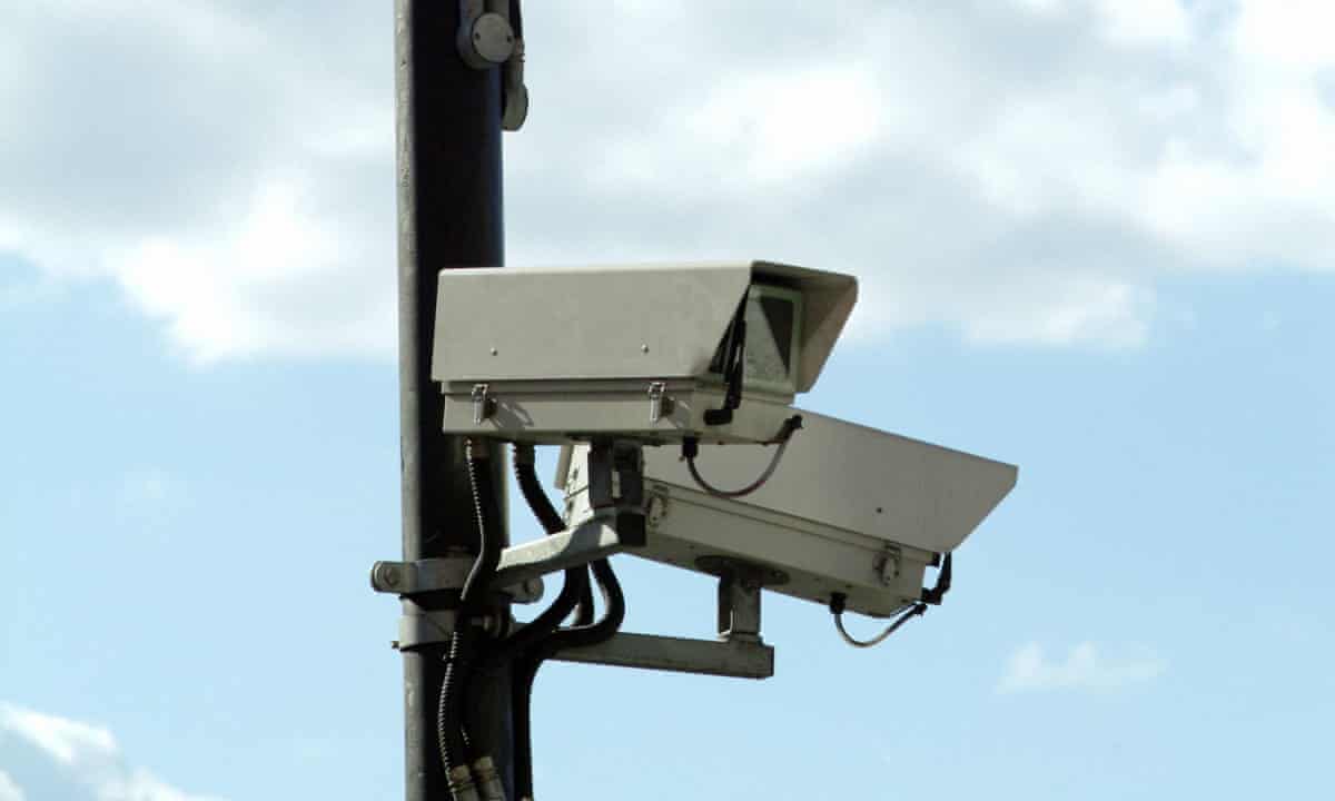 cctv cameras attached to an observation pole, with the sky and clouds in the background