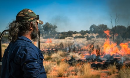 A ranger burning land