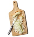 Chopped onion on a board with a knife