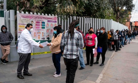 People who suspect they have Covid-19 line up for a second check at clinic in Tijuana, Mexico, on Monday.