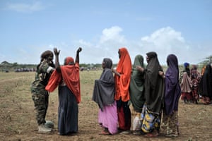 A female soldier of the African Union Mission in Somalia conducting a security check on a woman at a food distribution centre in Afgoye, Somalia.