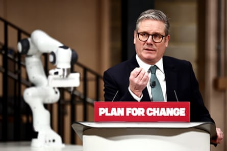 Starmer speaking at a podium with a sign reading ‘Plan for change’