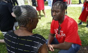 Democratic gubernatorial candidate Andrew Gillum talks with a supporter after speaking to voters and public school teachers at a rally in Miami Gardens, Florida.