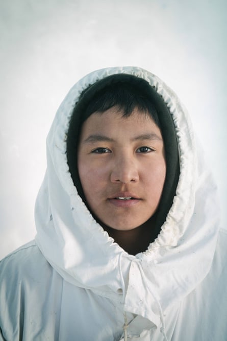 16-year old Yugu Ningeok, a member of an Iñupiaq whaling crew, wears his ice camoflauge cover, or qatiginisi. Yugu is named after his uncle, the original founder of the whaling crew.