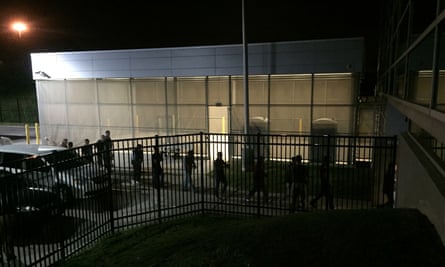 Detainees are escorted into an Ice facility in Brooklyn Heights, Ohio, on 20 June after over 140 workers were arrested at the Fresh Mark meatpacking plant.