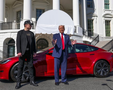 Trump and Musk standing in front of a red car