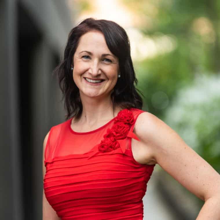 Assoc Prof Jane Tiller smiling in red top with long dark hair